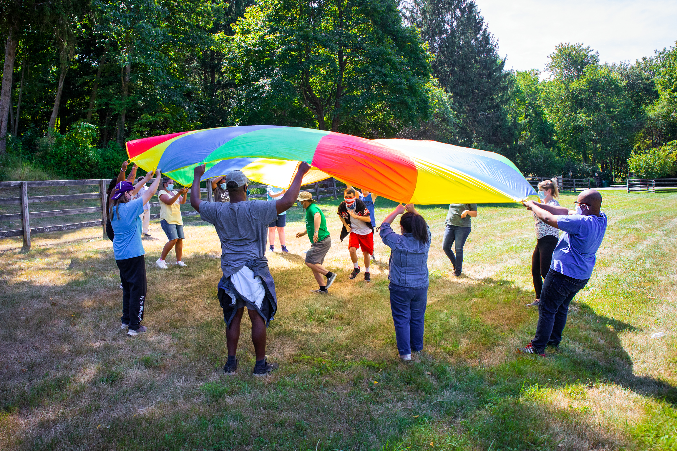 Joining friends under the parachute promotes recreation and fitness on the farm.