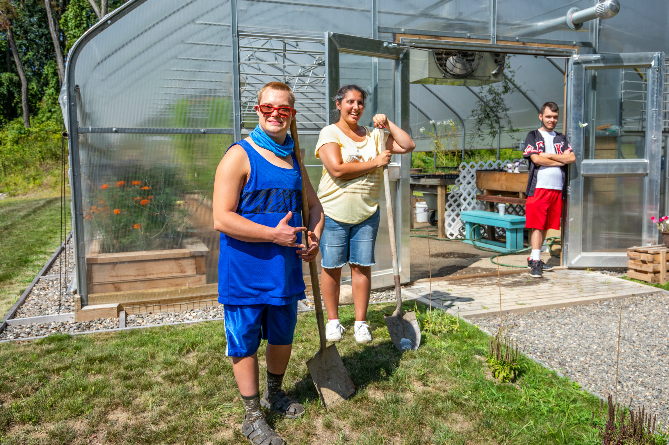 Working with shovels near the greenhouse is part of the agricultural vocational curriculum.