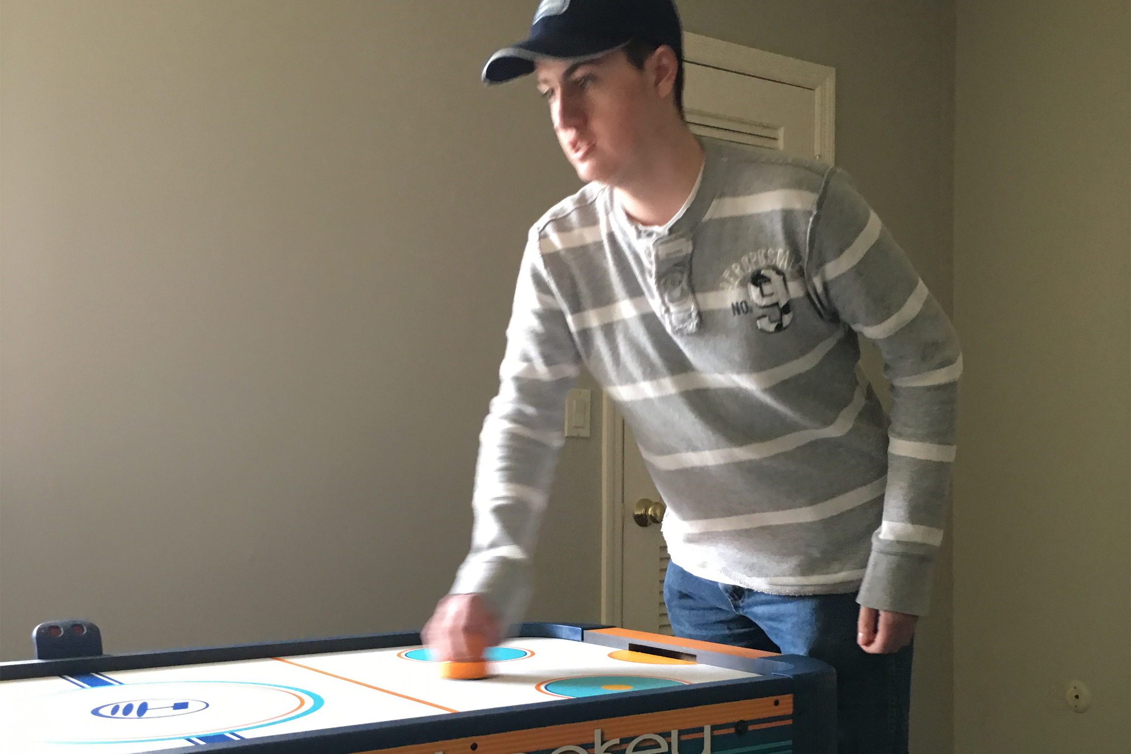 Playing with the air hockey table is a time for peer socialization.